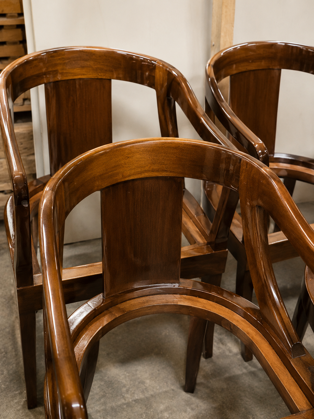 Curved mahogany barrel chairs assembled and finished, ready for quality check
